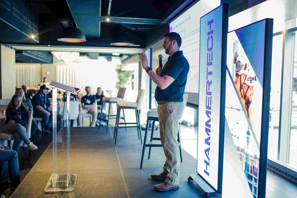 Dylan Hipple speaking at the North America community event in Chicago on stage.