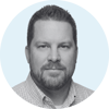 Justin Bell Headshot in Grayscale with light blue background