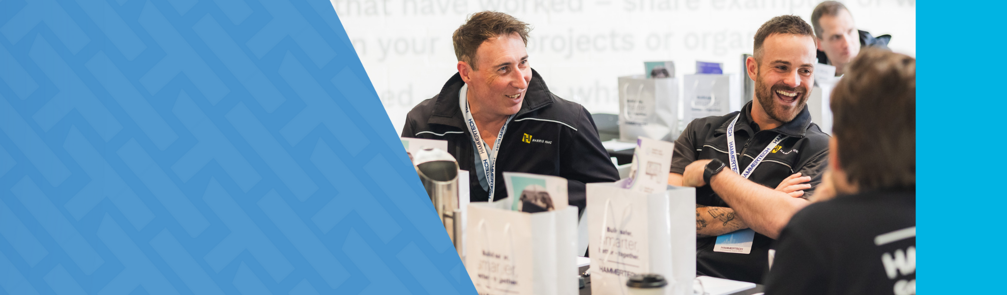 HammerTech community members in Australia attending the 2025 HammerTech Community Event, smiling and laughing with each other. 