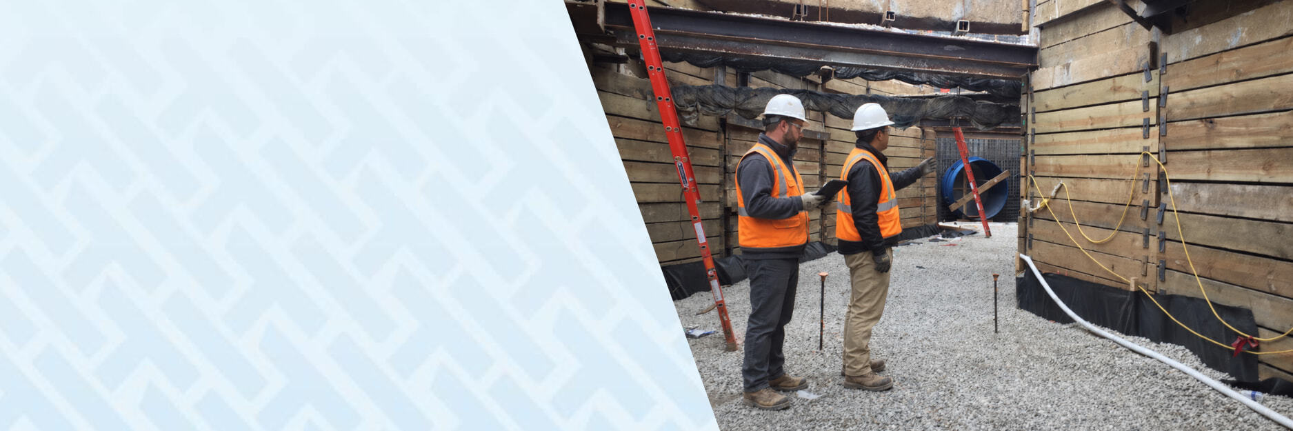 image of two workers in deep boarded-off section of construction site with one on his iPad and the other dictating work - using HammerTech construction safety software for Civil and Infrastructure.