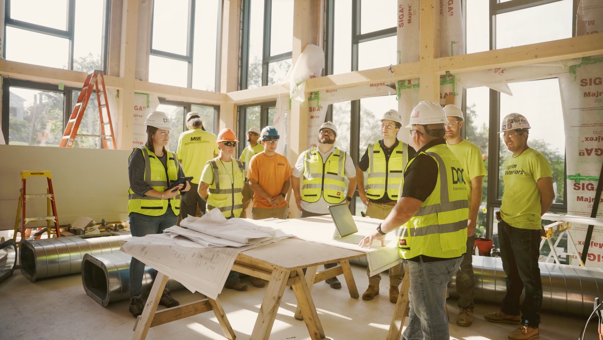 DOC workers having a safety meeting before the day begins, using HammerTech's Construction Safety Software.