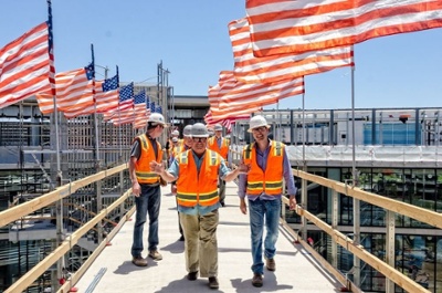 Group of DPR construction workers at a construction site walking and talking together.