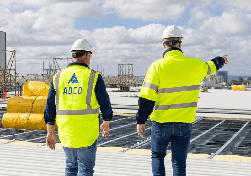 Image of two ADCO works on the top of an in-progress data center build