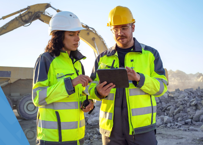 Image of Gray Construction workers on the job site on the right side with patterned HammerTech blue background on the left.
