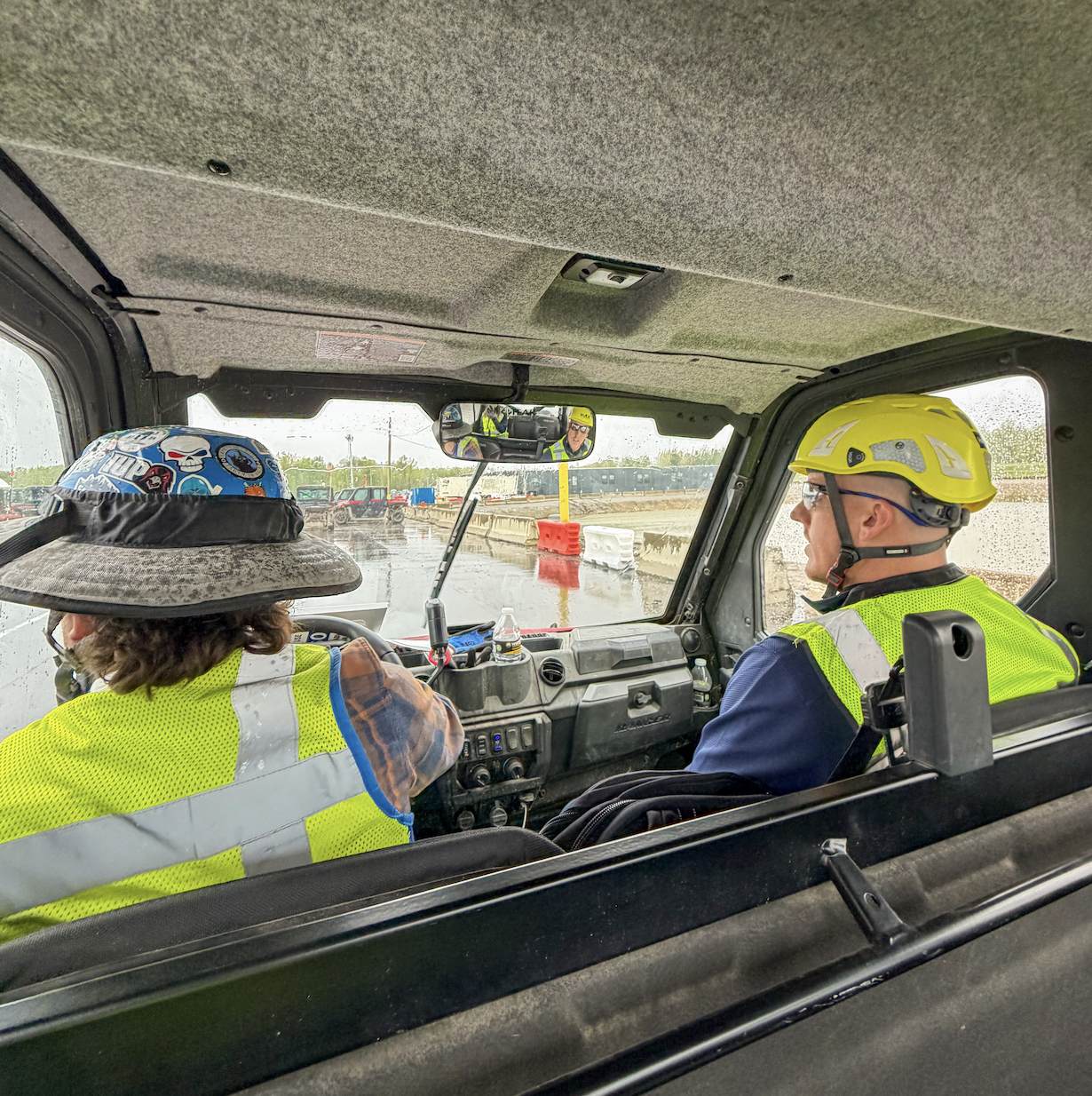 Holder construction workers in a truck on a job site