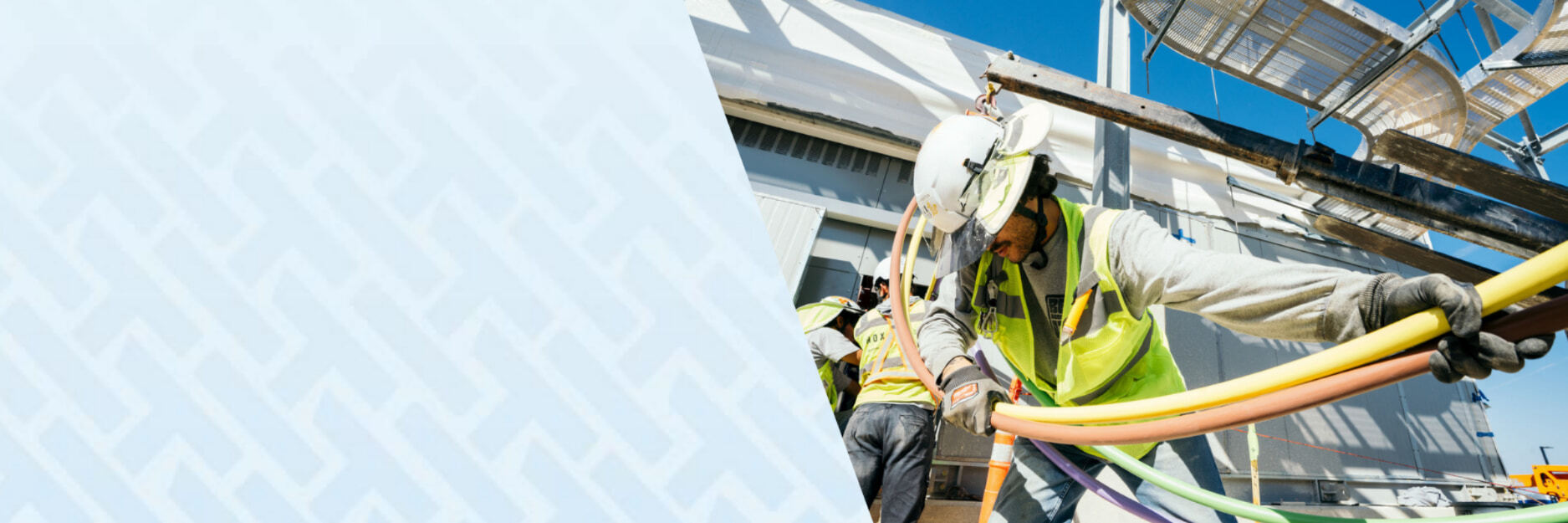Image of electricians pulling wire and tubes for commercial construction project that uses HammerTech construction safety software. Photo courtesy of Nox Group.