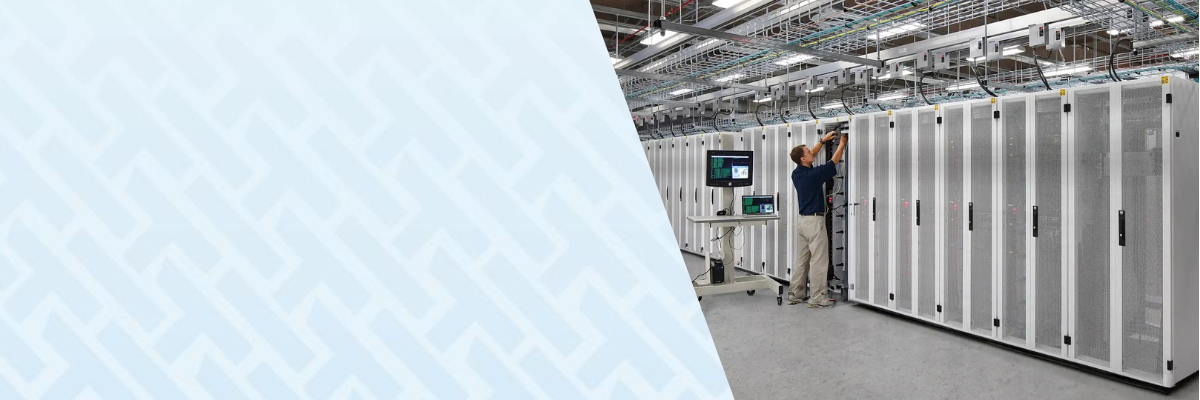 Technician working on server racks inside a large-scale data center facility with interconnected electrical systems and critical infrastructure supporting high-density operations