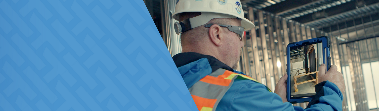 Blog header of a North America construction worker using a tablet.