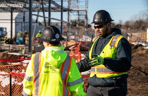 CRB construction workers discussing safety on a job site